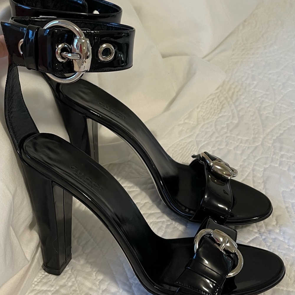 Gucci Black Patent 4” heels with ankle straps and statement silver buckles